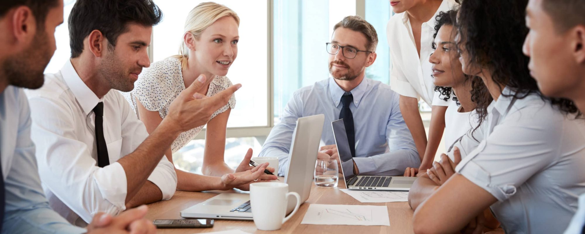 Group Of Businesspeople Meeting Around Table In Office